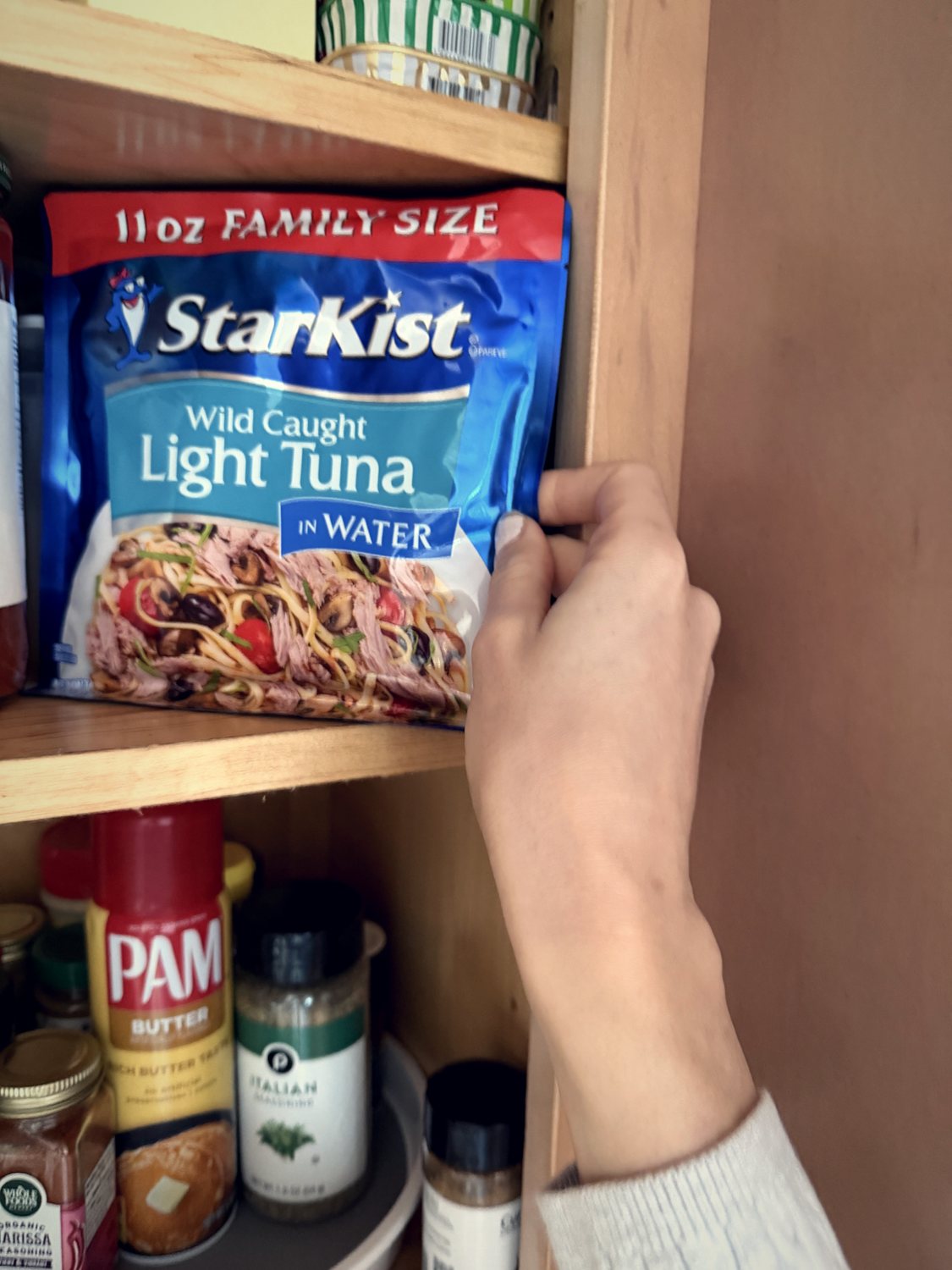 Reaching for a pouch of tuna in the pantry